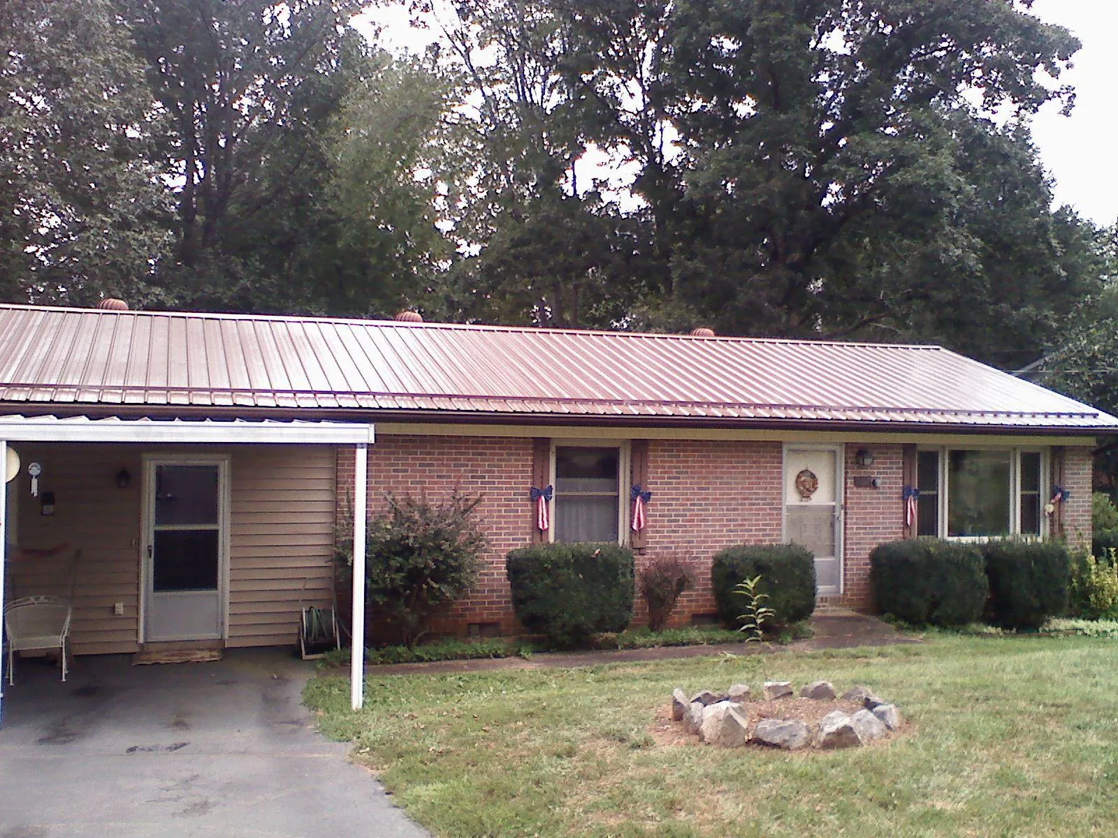 Bronze metal roof and carport on a brick ranch home — Roof Repair work by our crew in New Baltimore