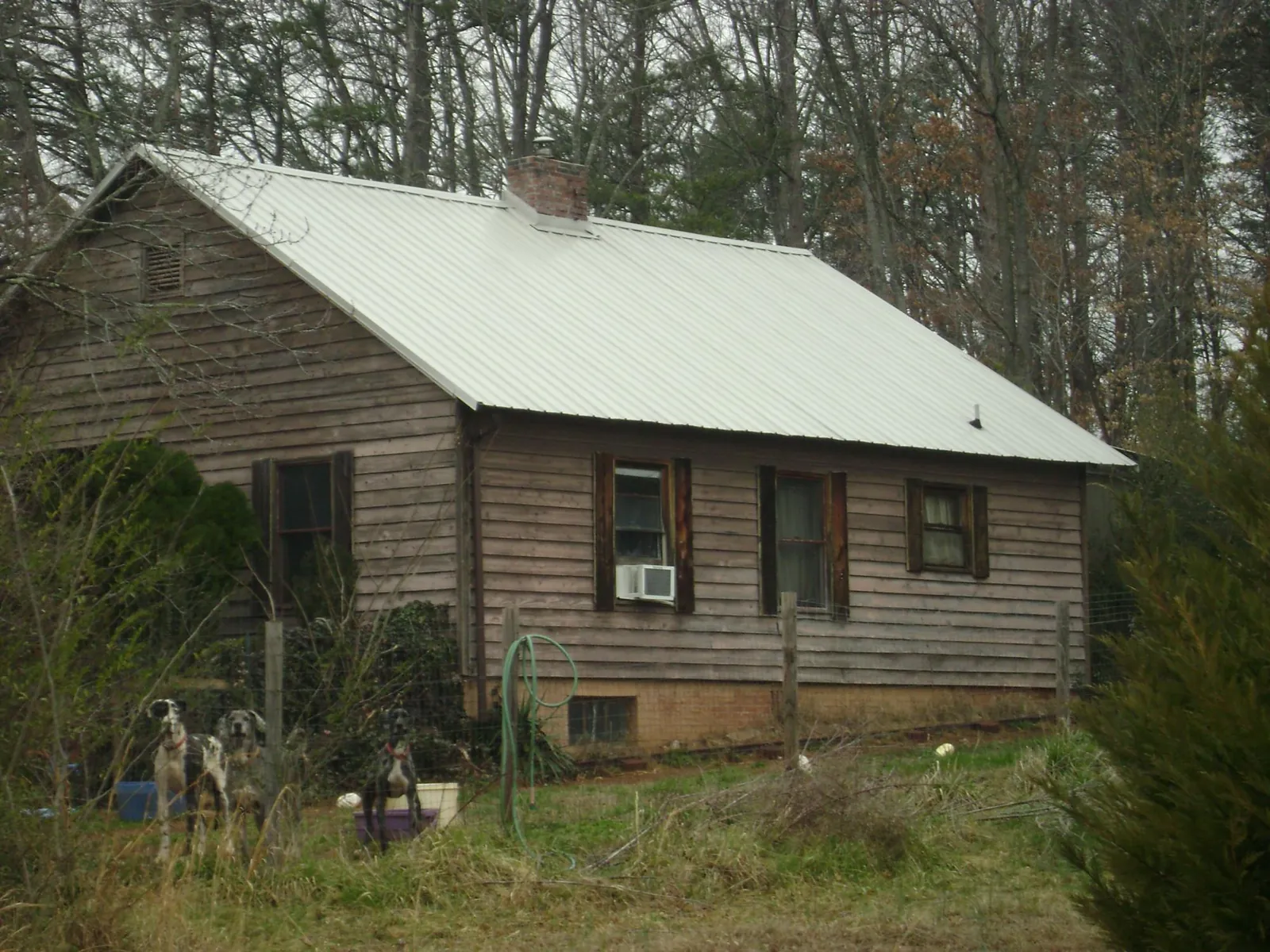 White metal roof on an old wood sided farmhouse, from a Metal Roof Installation job in New Baltimore
